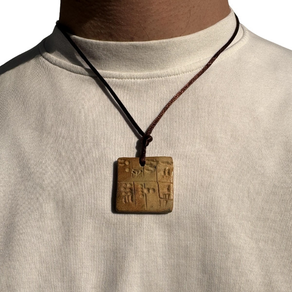A Handcrafted Necklace Designed as a Miniature Tablet, Featuring Ancient Sumerian Script